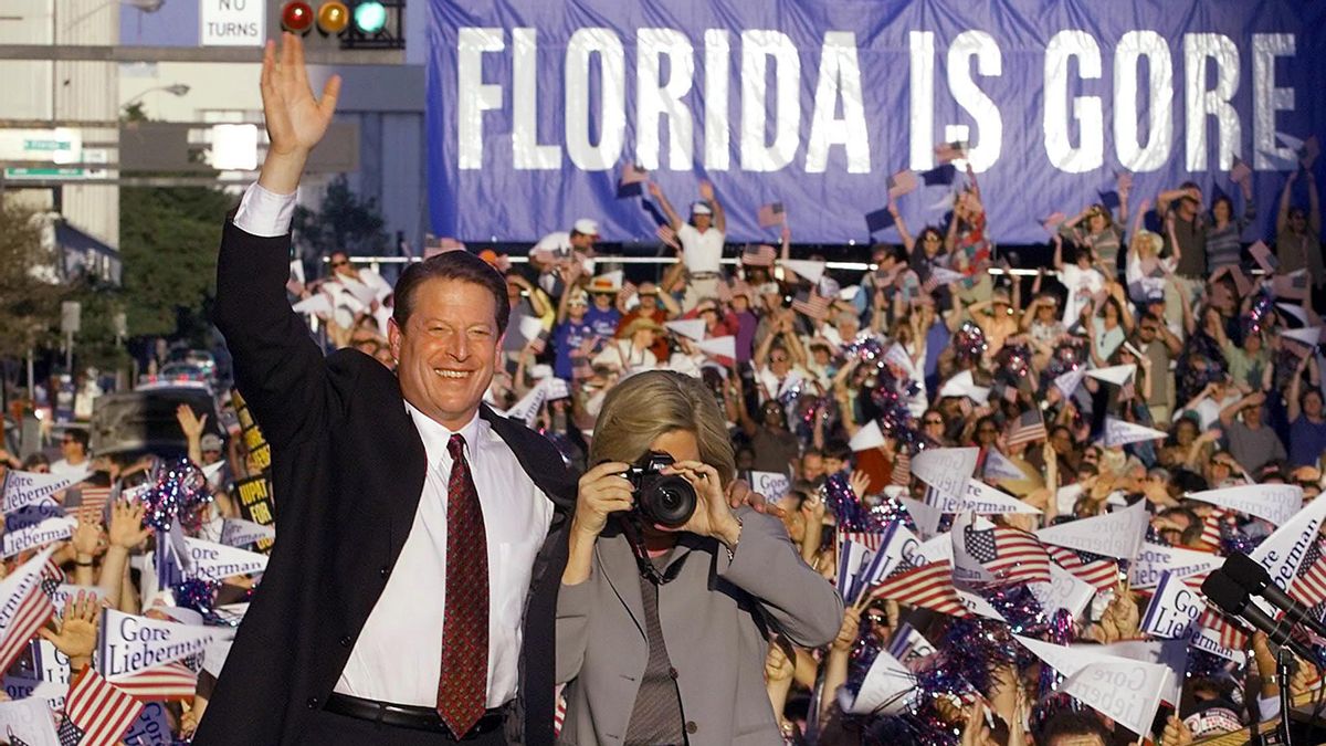 Democratic presidential candidate and US Vice President Al Gore (L) and his wife Tipper, taking photos, are introduced at a rally in Tampa, Florida, on Nov. 1, 2000, one week ahead of the presidential election. (Courtesy: LUKE FRAZZA/AFP via Getty Images) (LUKE FRAZZA/AFP via Getty Images)