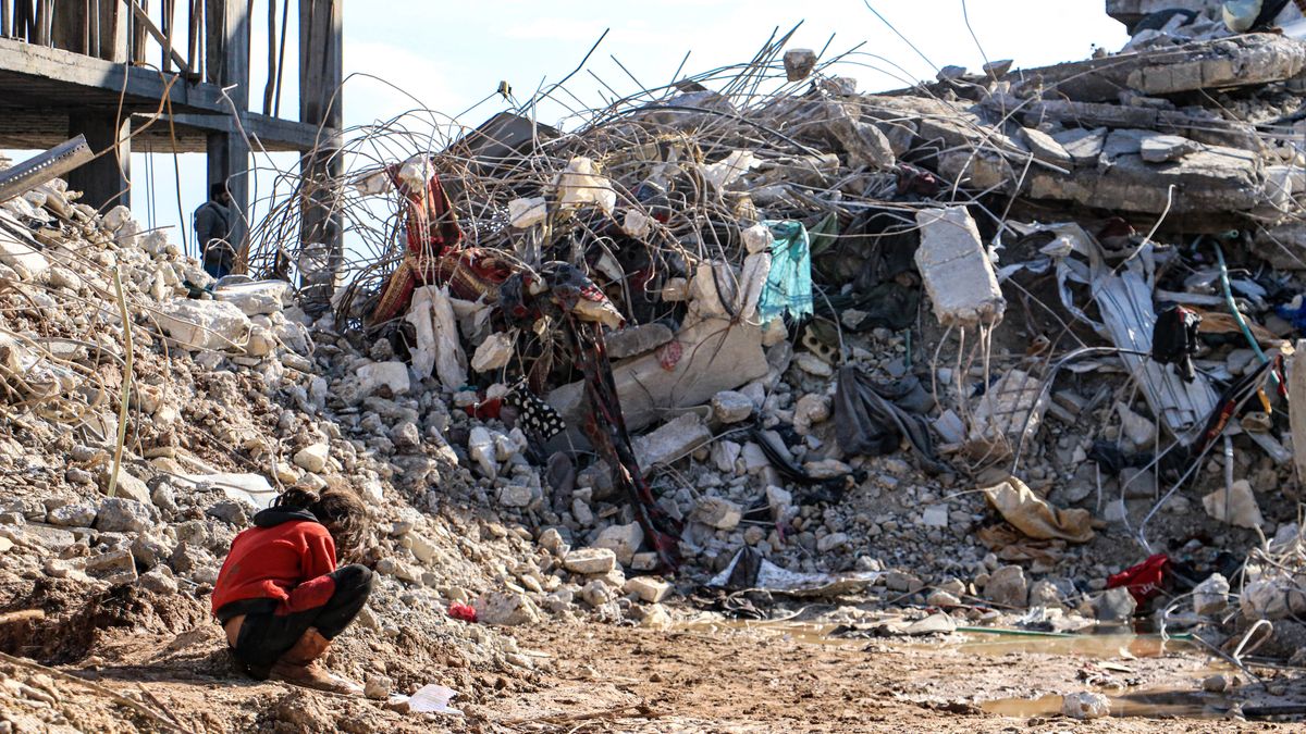 A child sits in front of a collapsed building following an earthquake on Feb. 7, 2023 in Afrin, Cinderes, Syria, a 7.8-magnitude quake that hit near Gaziantep, Turkey. (Photo by Ugur Yildirim / dia images via Getty Images) (Ugur Yildirim / dia images via Getty Images (Afrin, Cinderes, Syria on Feb. 7, 2023))
