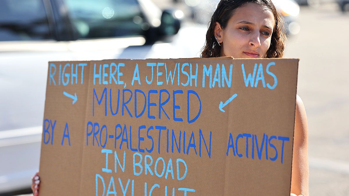 A demonstrator holds a sign at a makeshift memorial at the site of an altercation between 69-year-old Paul Kessler, who was Jewish, and a pro-Palestinian protestor on Nov. 7, 2023 in Thousand Oaks, California. (Photo by Mario Tama/Getty Images) (Mario Tama/Getty Images)