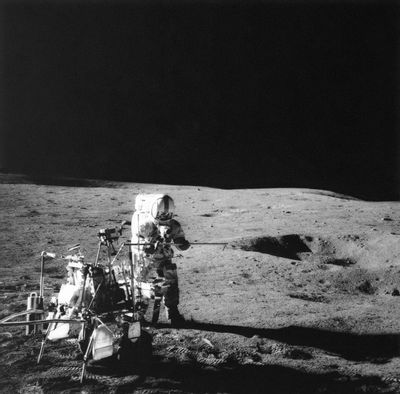 FILE - In this Feb. 6, 1971, file photo, Apollo 14 astronaut Alan B. Shepard Jr. conducts an experiment near a lunar crater using an instrument from a two-wheeled cart carrying various test tools. Apollo 14 commander Alan B. Shepard Jr. and his crew brought back 42 kilograms of moon rocks. Left behind were two golf balls that Shepard, who later described the moon's surface as “one big sand trap,” hit with a makeshift 6-iron to become a footnote in history. (NASA via AP, File)
