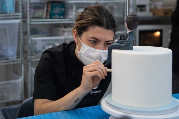 MILAN, ITALY - MAY 08: Cake designer Costanza Dones, wearing a protective face mask, uses a brush to decorate a sugar paste birthday cake as she works at Mami Louise Milano Cake Design and Pastry Lab on May 08, 2020 in Milan, Italy. Italy was the first country to impose a nationwide lockdown to stem the transmission of the Coronavirus (Covid-19), and its restaurants, theaters and many other businesses remain closed. (Photo by Emanuele Cremaschi/Getty Images) (Getty Images)