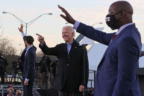 ATLANTA, GEORGIA - JANUARY 04: President-elect Joe Biden (C) rallys with Democratic candidates for the U.S. Senate Jon Ossoff (L) and Rev. Raphael Warnock (R) the day before their runoff election in the parking lot of Center Parc Stadium January 04, 2021 in Atlanta, Georgia. Biden's trip comes a day after the release of a recording of an hourlong call where President Donald Trump seems to pressure Georgia Secretary of State Brad Raffensperger to “find” the votes he would need to reverse the presidential election outcome in the state. (Photo by Chip Somodevilla/Getty Images) (Chip Somodevilla/Getty Images)