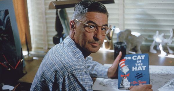 American author and illustrator Dr Seuss (Theodor Seuss Geisel, 1904 - 1991) sits at his drafting table in his home office with a copy of his book, 'The Cat in the Hat', La Jolla, California, April 25, 1957.  (Photo by Gene Lester/Getty Images) (Gene Lester/Getty Images)