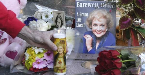 HOLLYWOOD, CALIFORNIA - DECEMBER 31: A mourner places a candle on the Hollywood Walk of Fame star of late actress Betty White on December 31, 2021 in Hollywood, California. (Photo by Rodin Eckenroth/Getty Images) (Rodin Eckenroth/Getty Images)
