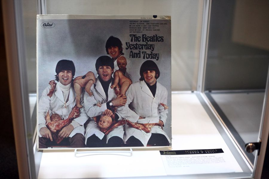 A cover of The Beatles' album "Yesterday And Today" shows four white men holding butcher's meat and decapitated baby dolls.